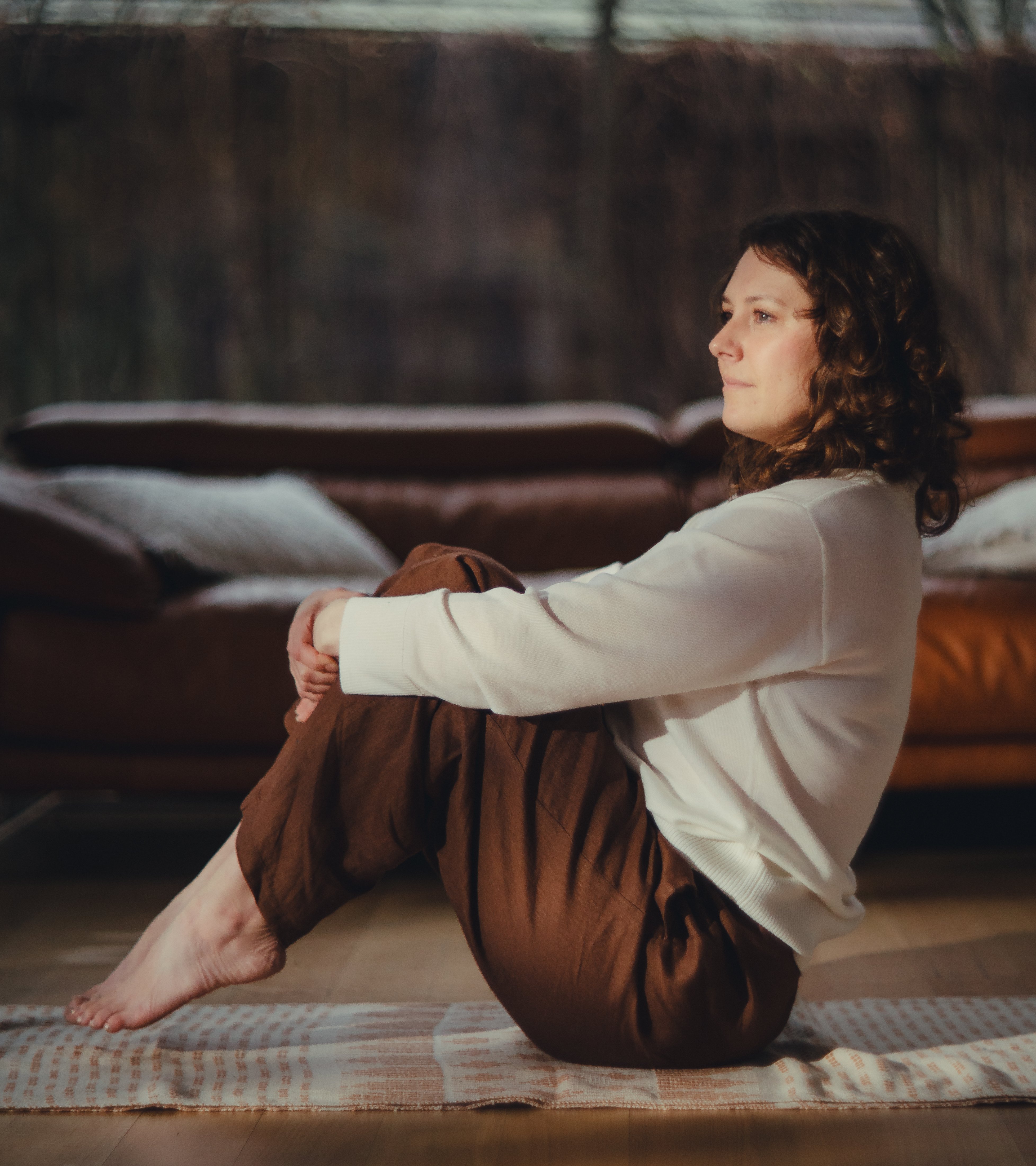 Beautiful boat pose demonstration in warm natural light home studio setting