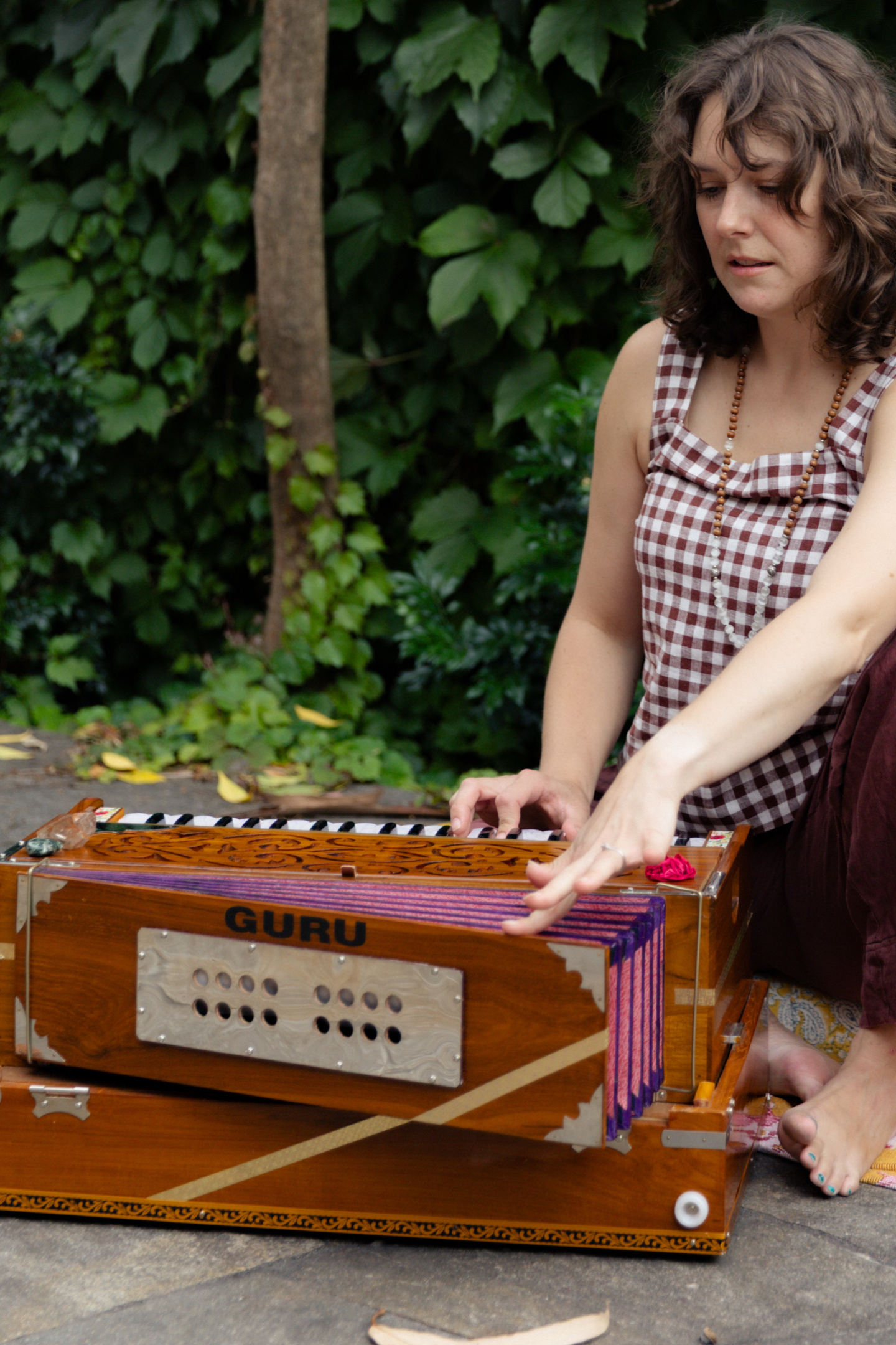 Erin playing harmonium during sound meditation practice at Beautiful Yoga Melbourne