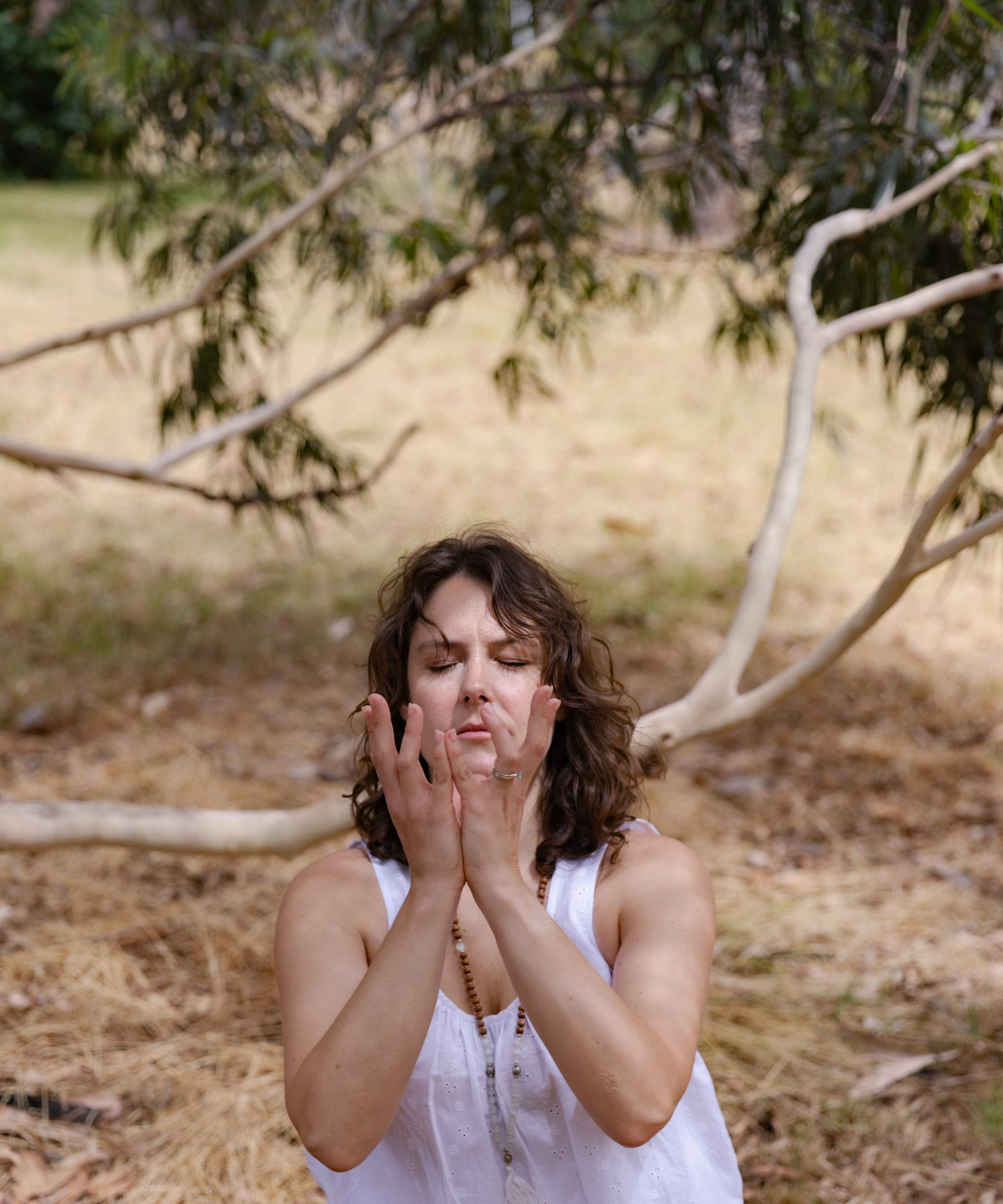 Erin from Beautiful Yoga in meditation with eucalyptus trees, Blackburn Melbourne